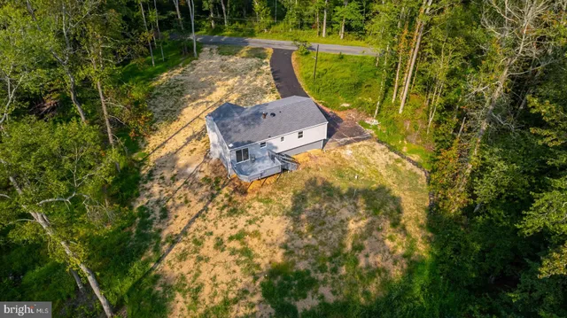 an aerial view of a house with a yard swimming pool outdoor seating and yard
