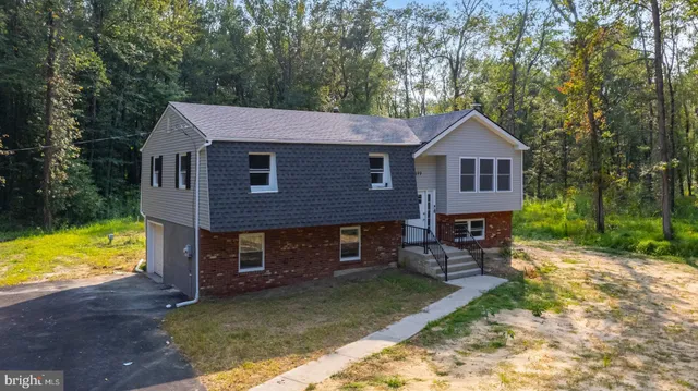 a front view of a house with a yard table and chairs