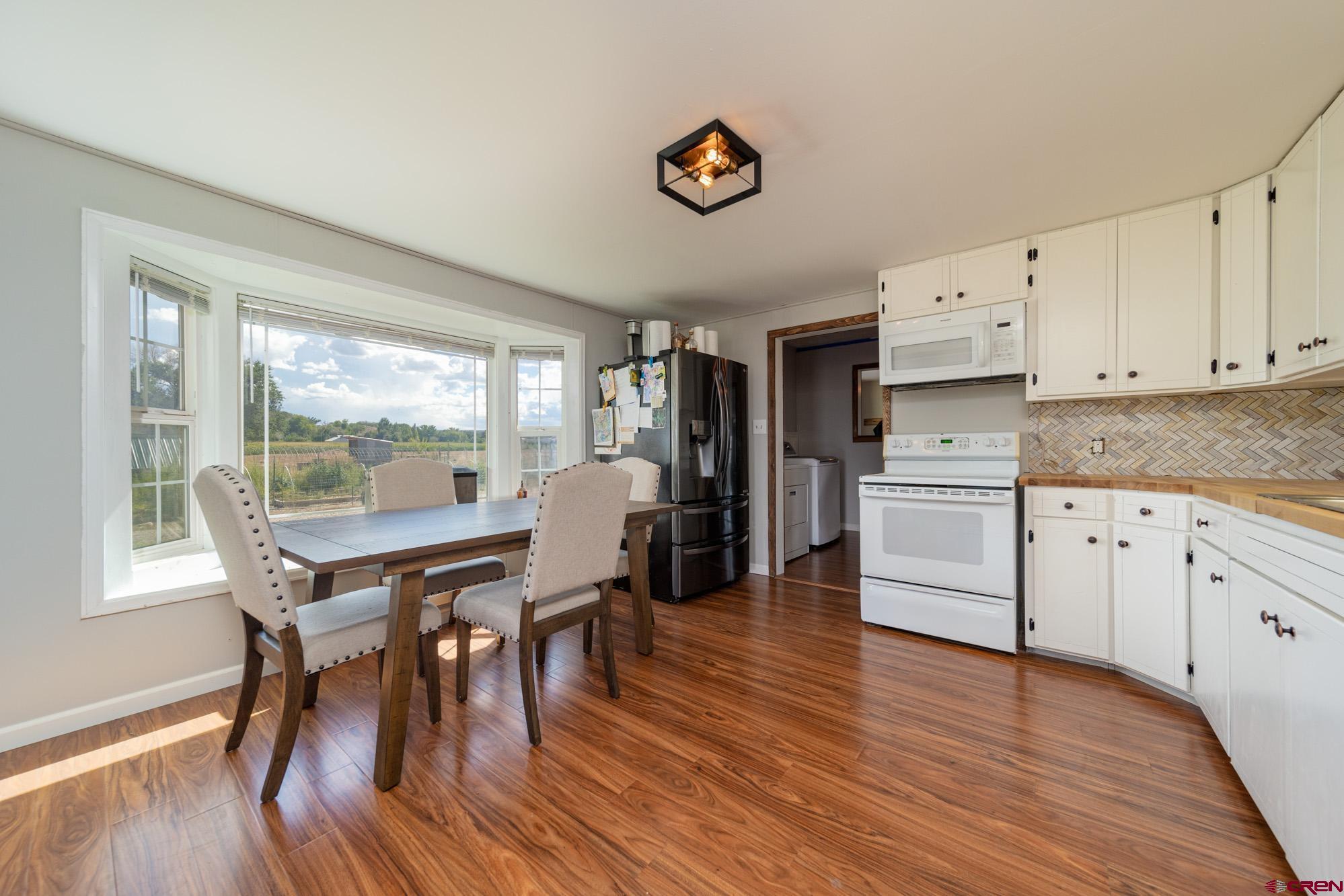 52888 Cornflower Road Delta, CO 81416 - Photo 11 of 28 a view of a dining room with furniture and wooden floor