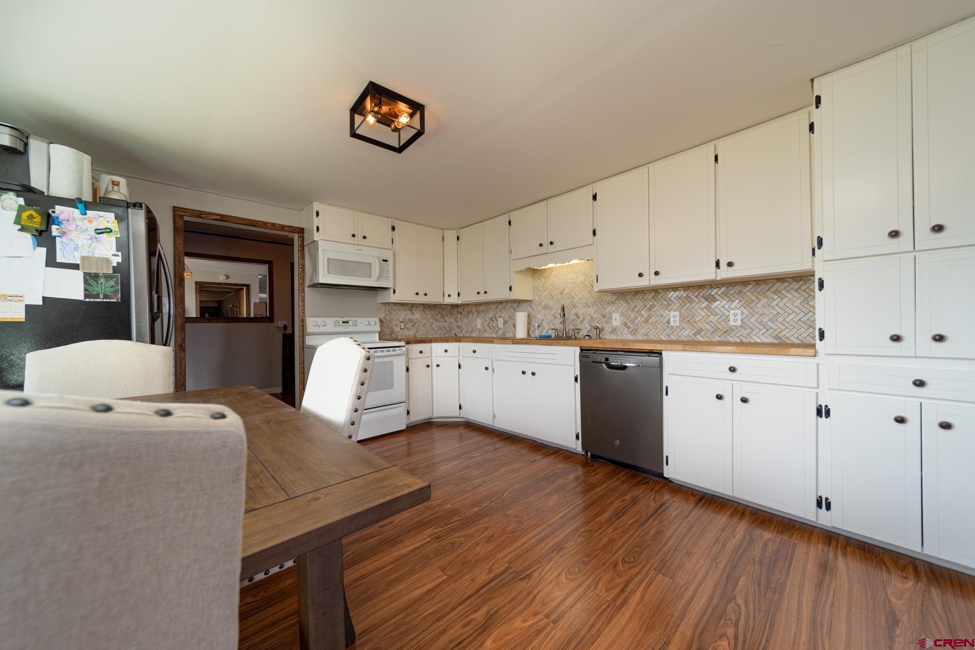 52888 Cornflower Road Delta, CO 81416 - Photo 12 of 28 a kitchen with cabinets wooden floor and a fireplace