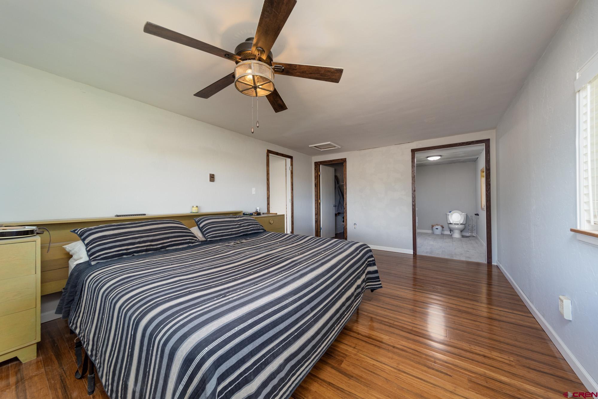 52888 Cornflower Road Delta, CO 81416 - Photo 15 of 28 a bedroom with double bed and a chandelier