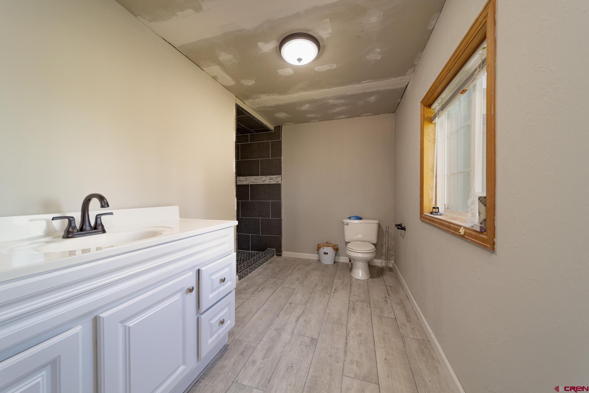 52888 Cornflower Road Delta, CO 81416 - Photo 17 of 28 a spacious bathroom with a double vanity sink and a toilet