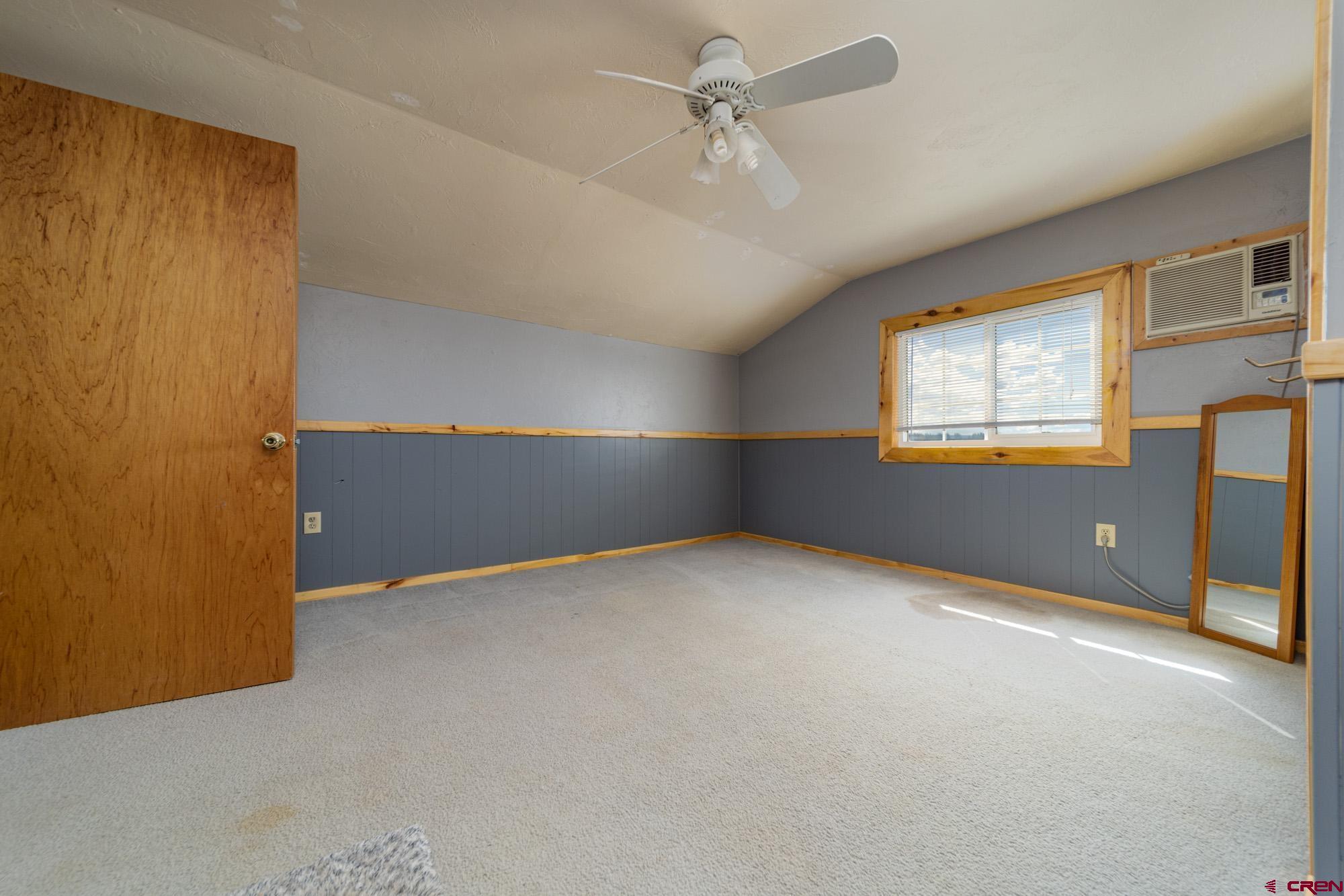 52888 Cornflower Road Delta, CO 81416 - Photo 20 of 28 an empty room with windows and ceiling fan