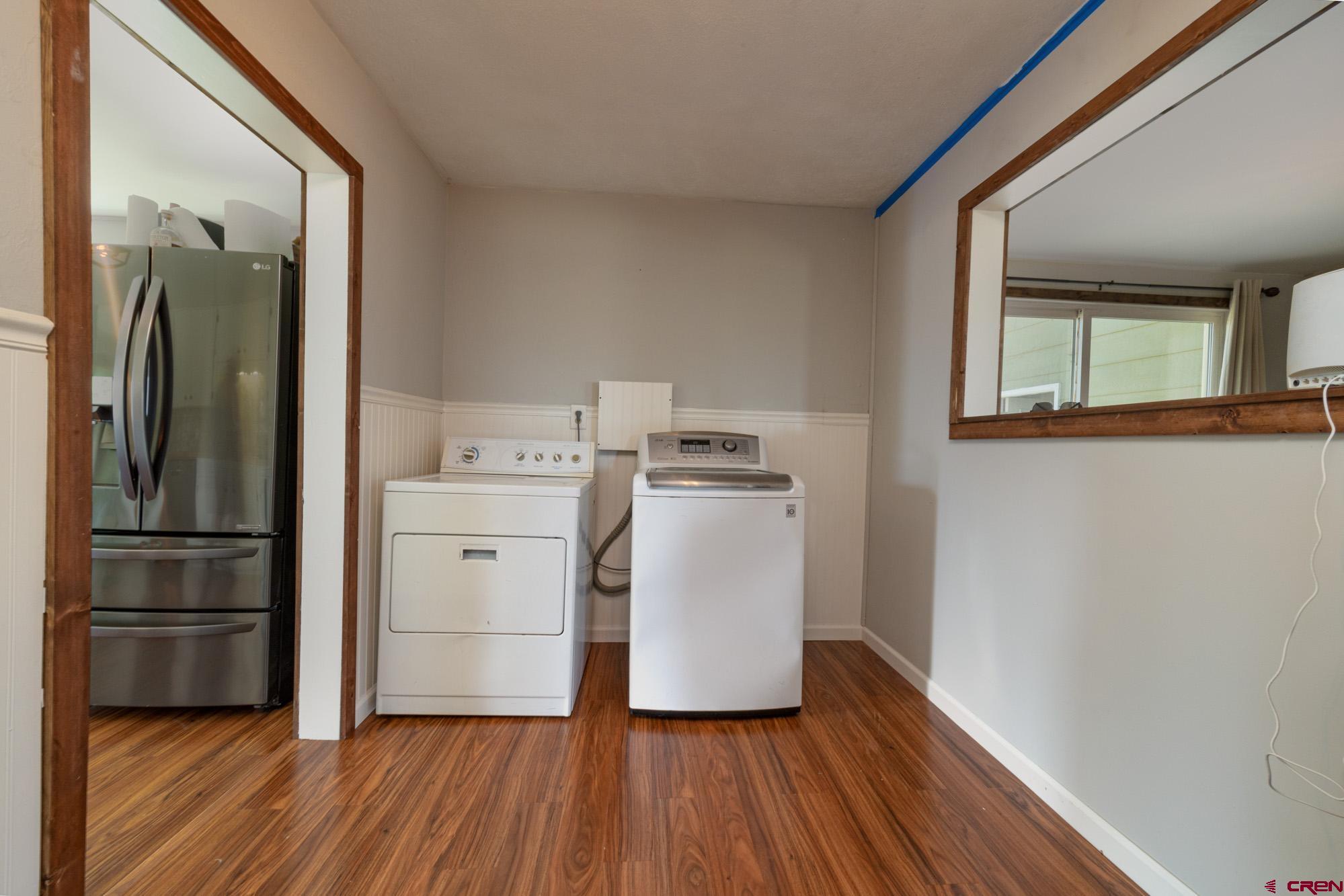 52888 Cornflower Road Delta, CO 81416 - Photo 23 of 28 a kitchen with wooden floors and white appliances