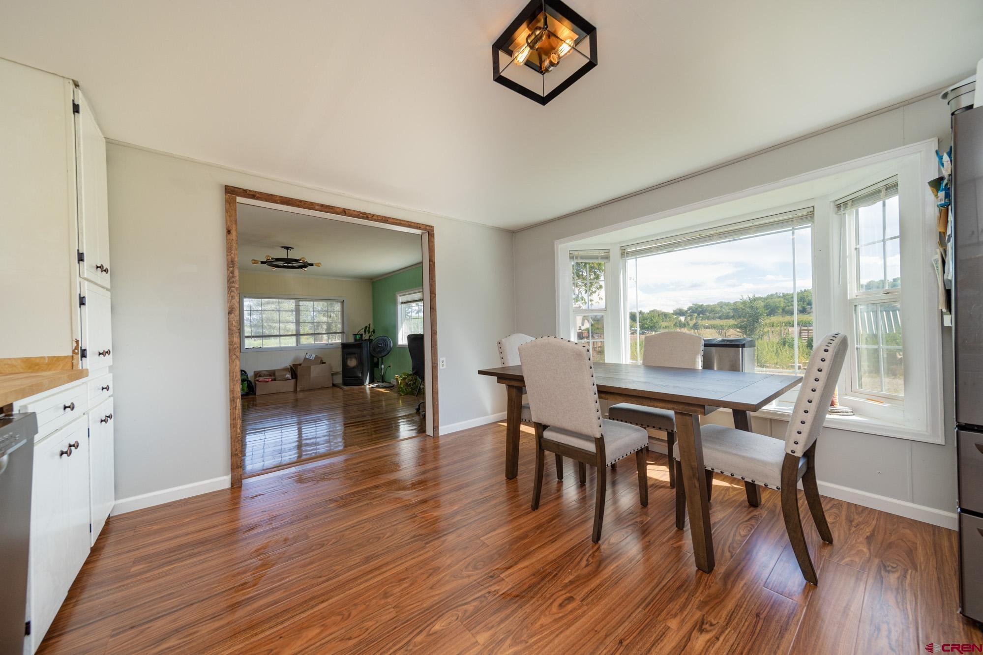 52888 Cornflower Road Delta, CO 81416 - Photo 10 of 28 a view of a dining room with furniture window and wooden floor
