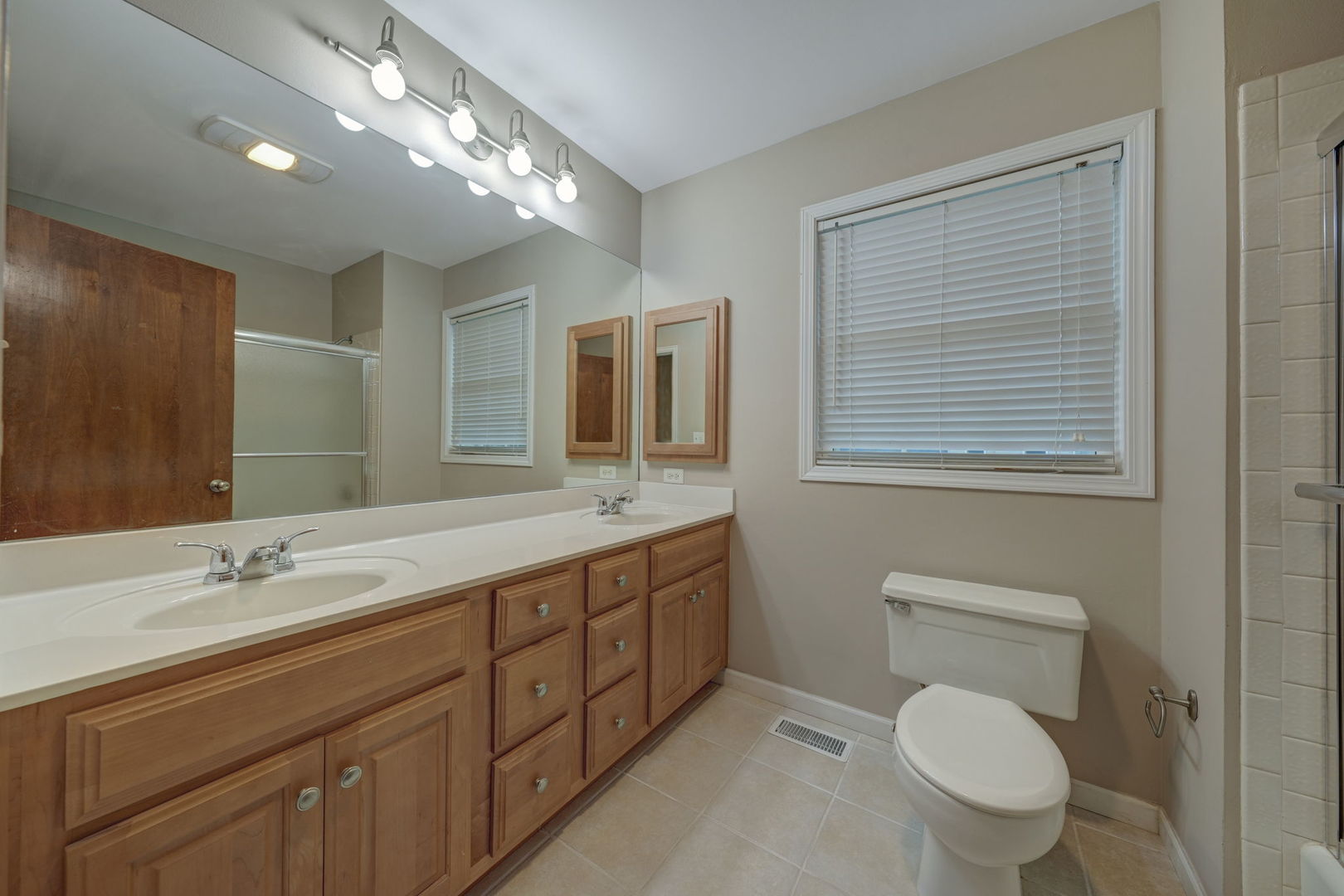 4977 Prairie Oak Road Gurnee, IL 60031 - Photo 22 of 26 a bathroom with a toilet a sink and mirror