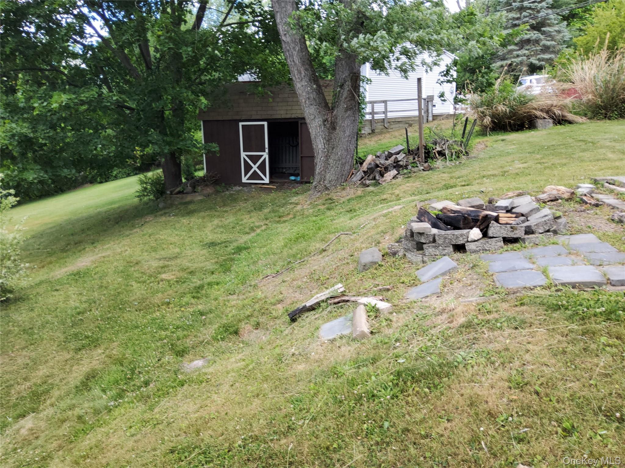 469 Hillside Road Monroe, NY 10950 - Photo 16 of 20 a backyard of a house with yard and outdoor seating