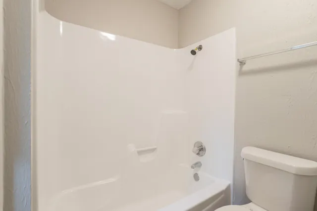 a bathroom with a bathtub and a toilet