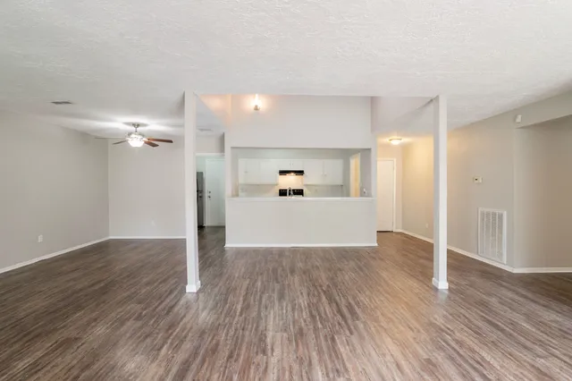 a view of a kitchen with wooden floor and a sink