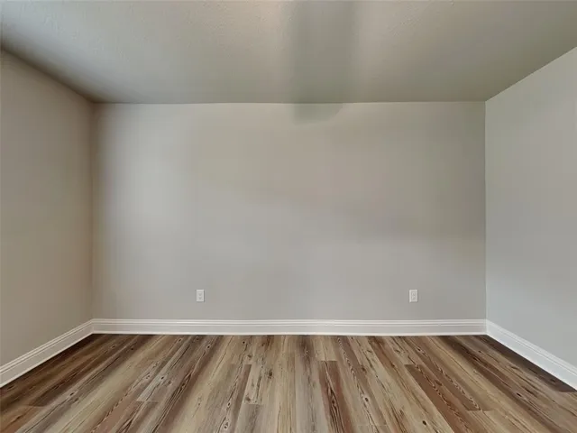a view of an empty room and wooden floor