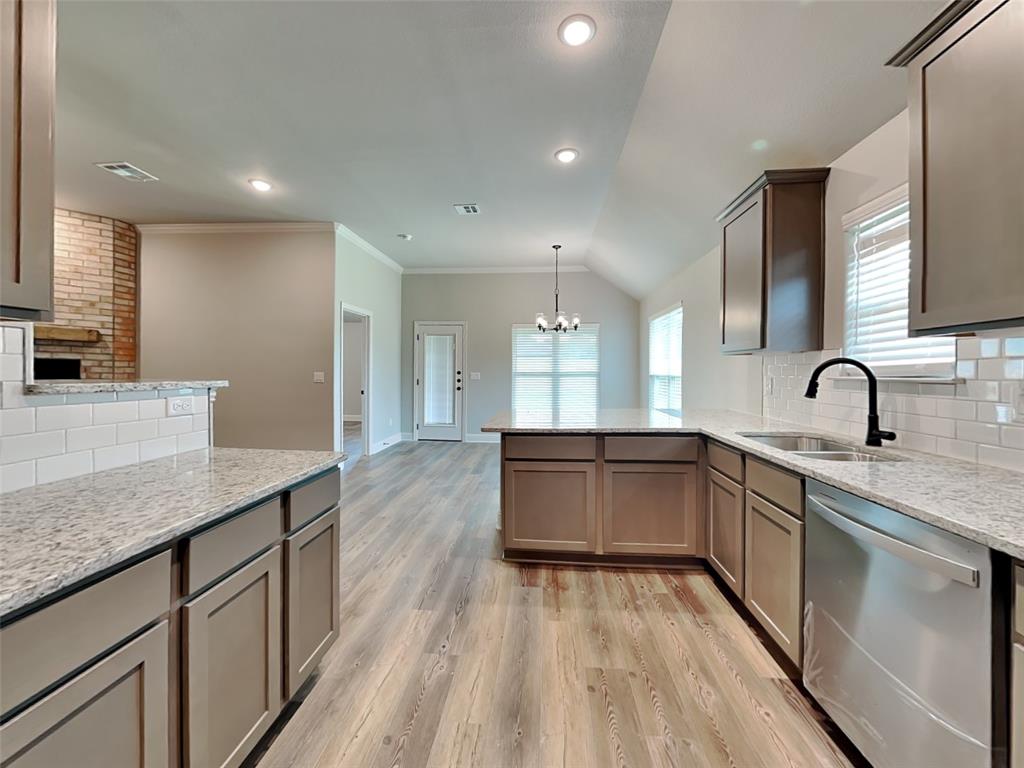 2108 Gabriel Drive Sherman, TX 75092 - Photo 3 of 16 a large kitchen with stainless steel appliances a large counter top a stove a sink and a refrigerator