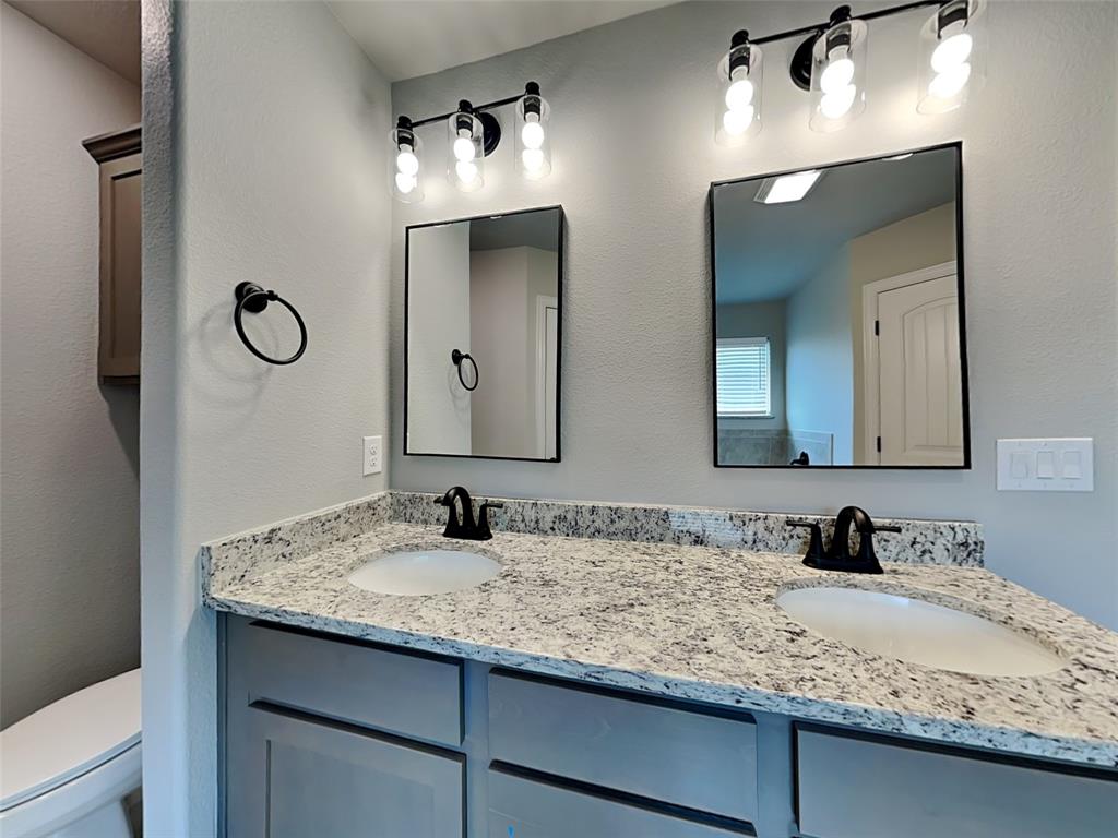 2108 Gabriel Drive Sherman, TX 75092 - Photo 8 of 16 a bathroom with double vanity sinks and a mirror