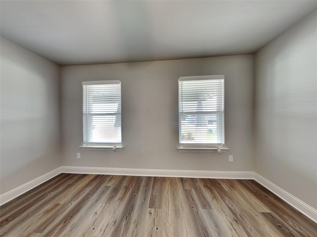 2108 Gabriel Drive Sherman, TX 75092 - Photo 10 of 16 an empty room with wooden floor and windows