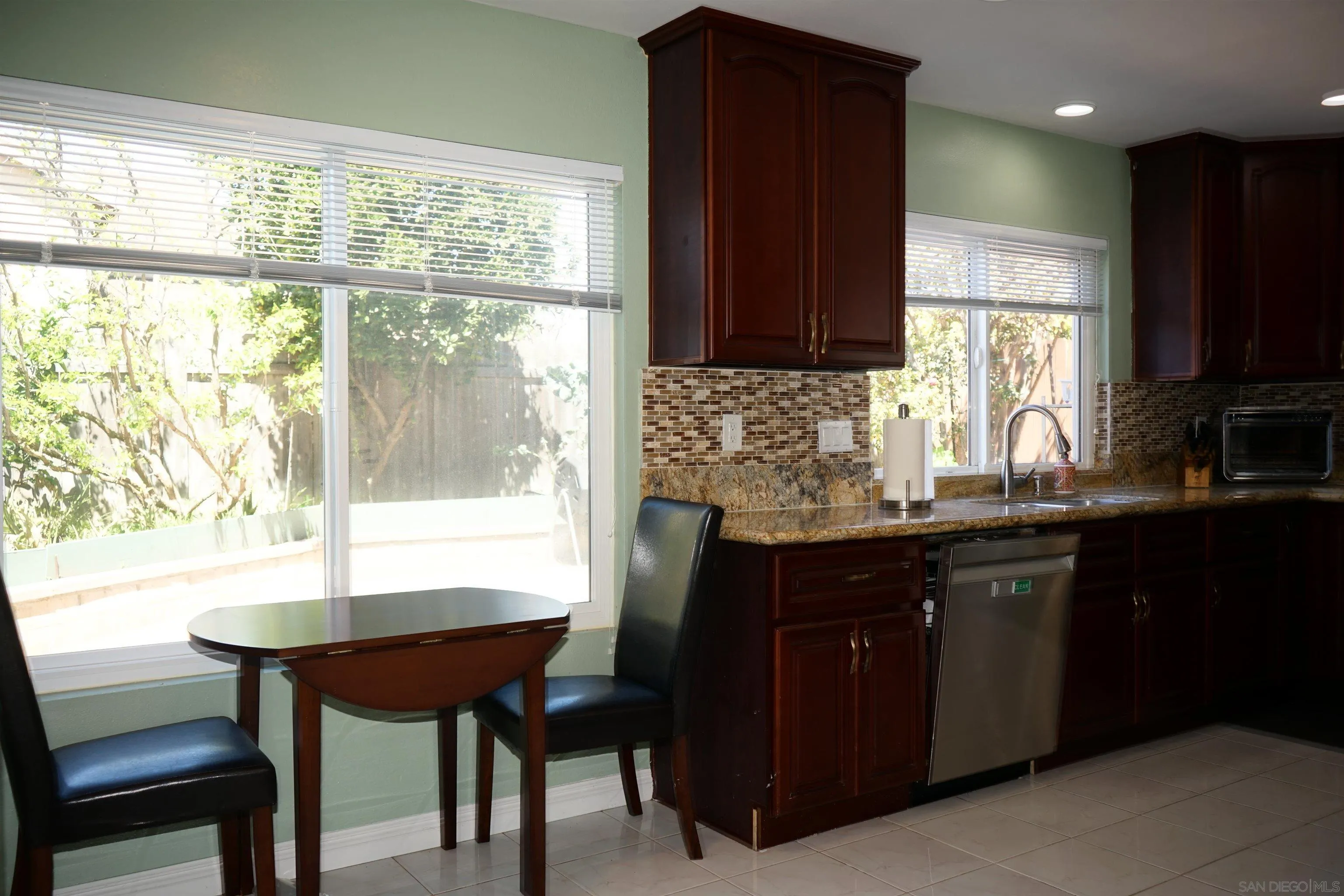 7842 Hemphill Drive San Diego, CA 92126 - Photo 11 of 29 a kitchen with a counter top a sink cabinets and appliances