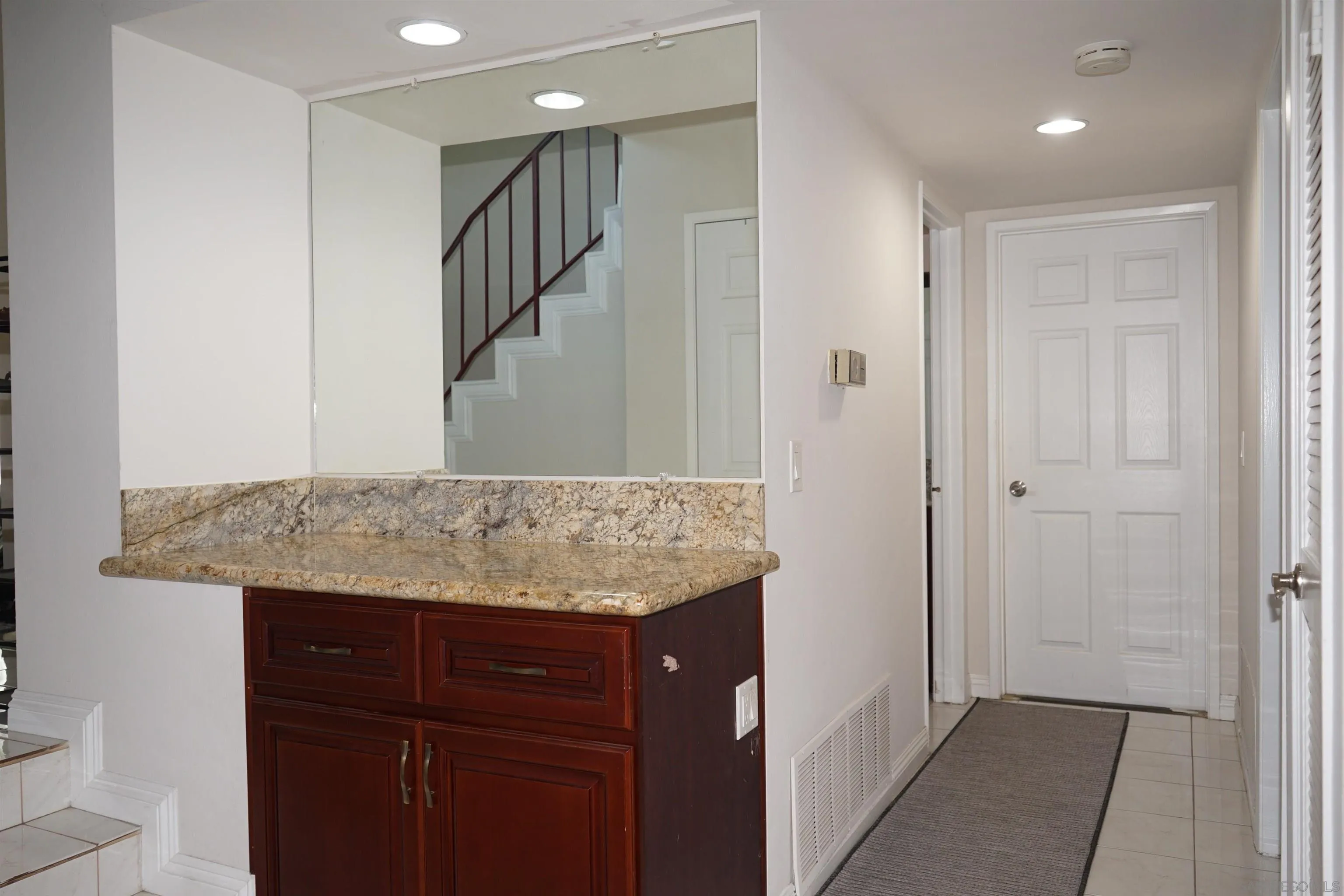 7842 Hemphill Drive San Diego, CA 92126 - Photo 15 of 29 a bathroom with a granite countertop sink and a mirror
