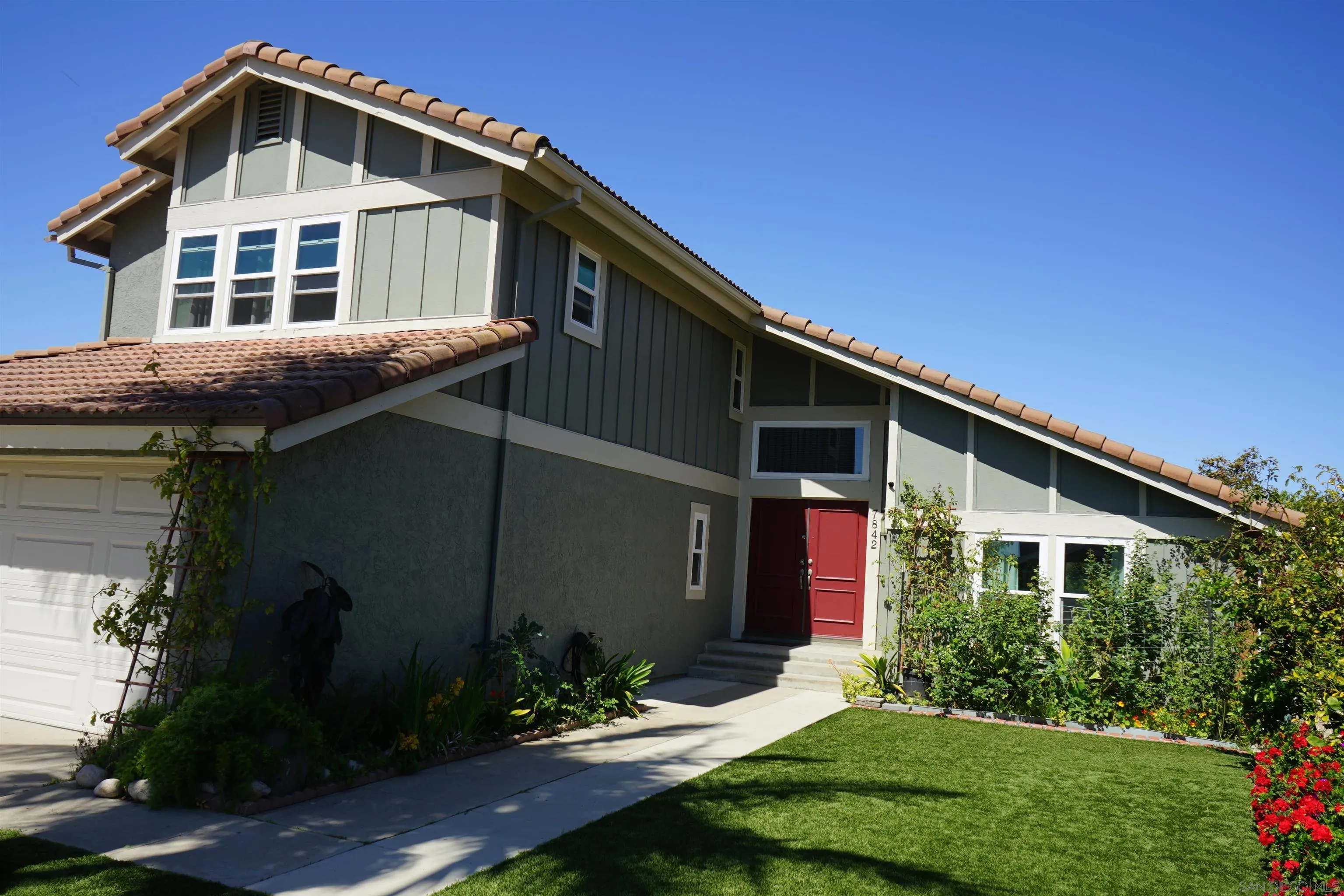 7842 Hemphill Drive San Diego, CA 92126 - Photo 2 of 29 a front view of a house with a yard