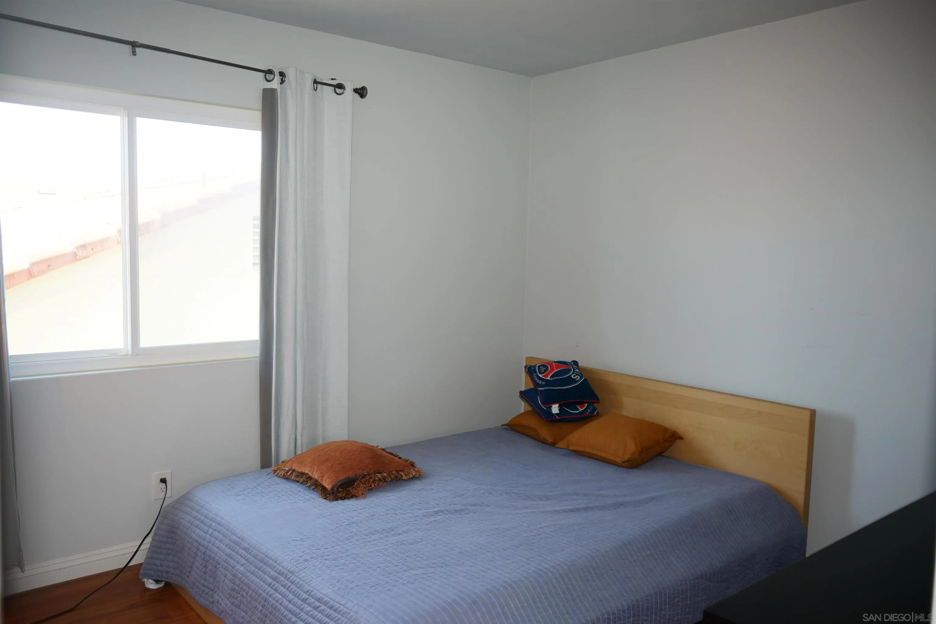 7842 Hemphill Drive San Diego, CA 92126 - Photo 21 of 29 a bedroom with a bed and window