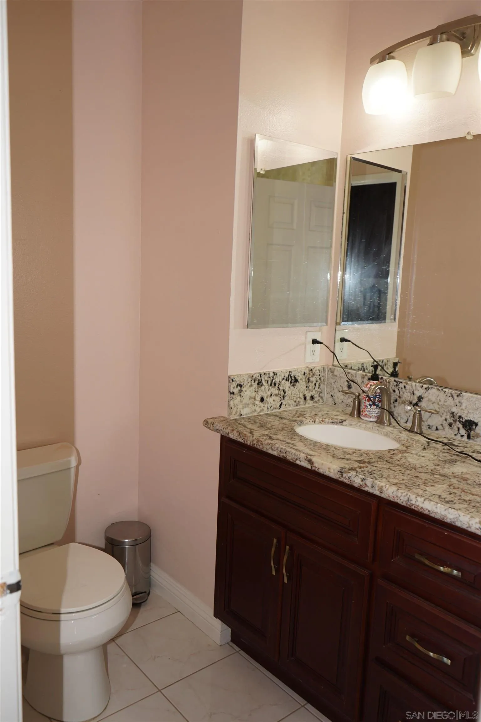 7842 Hemphill Drive San Diego, CA 92126 - Photo 22 of 29 a bathroom with a granite countertop sink toilet and mirror