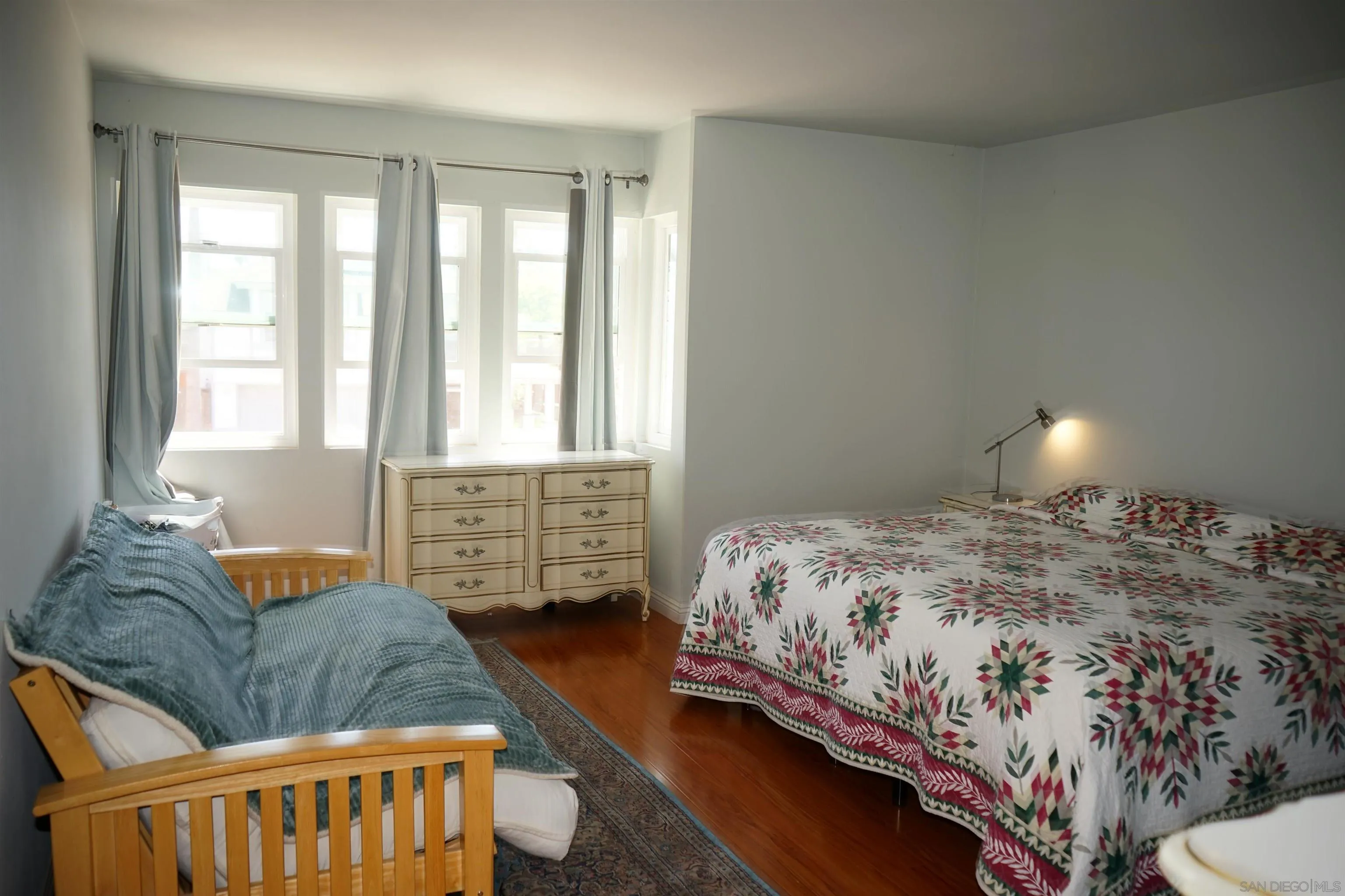 7842 Hemphill Drive San Diego, CA 92126 - Photo 24 of 29 a bedroom with bed couch and window