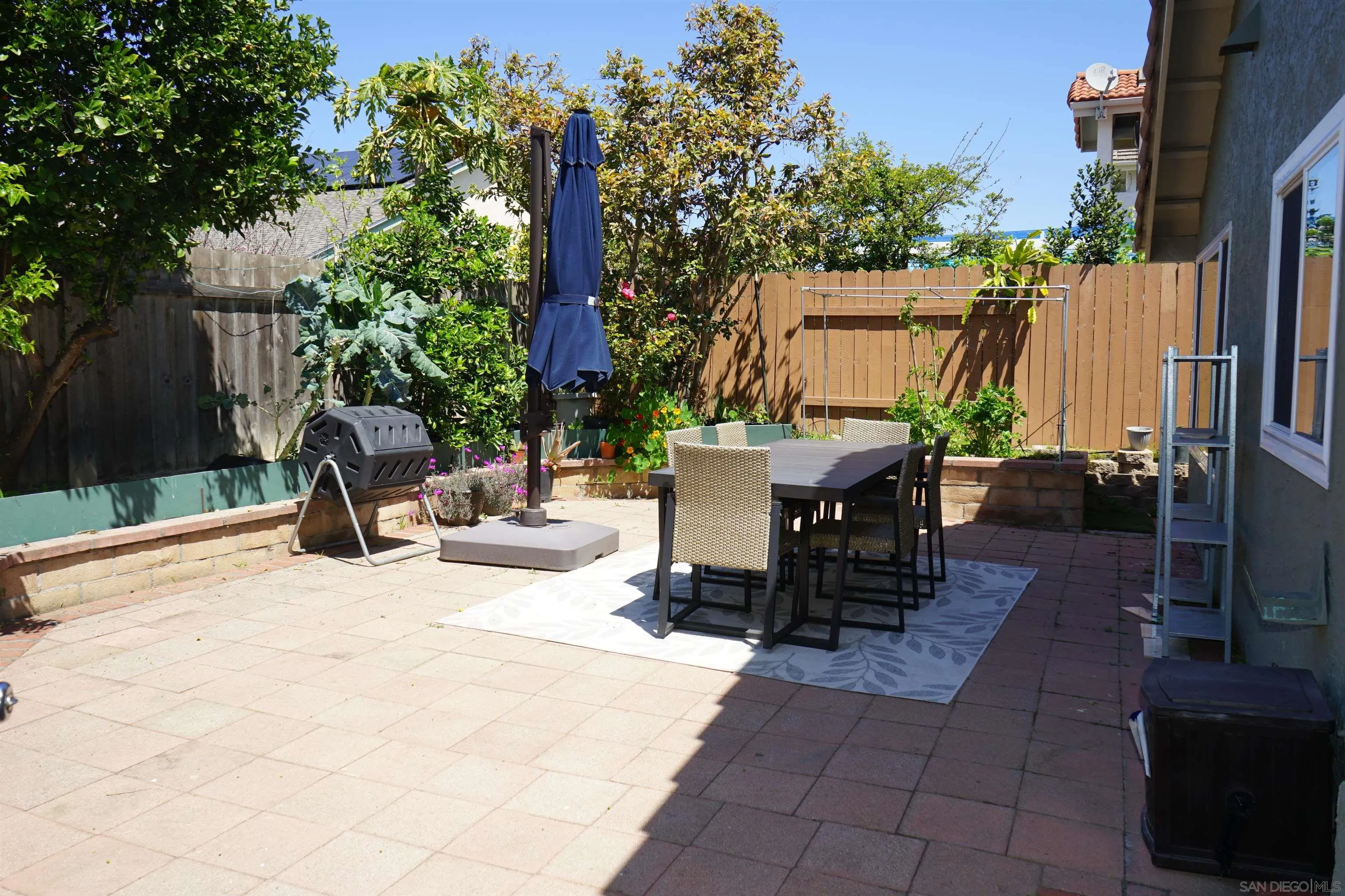 7842 Hemphill Drive San Diego, CA 92126 - Photo 28 of 29 a view of a patio with a table and chairs