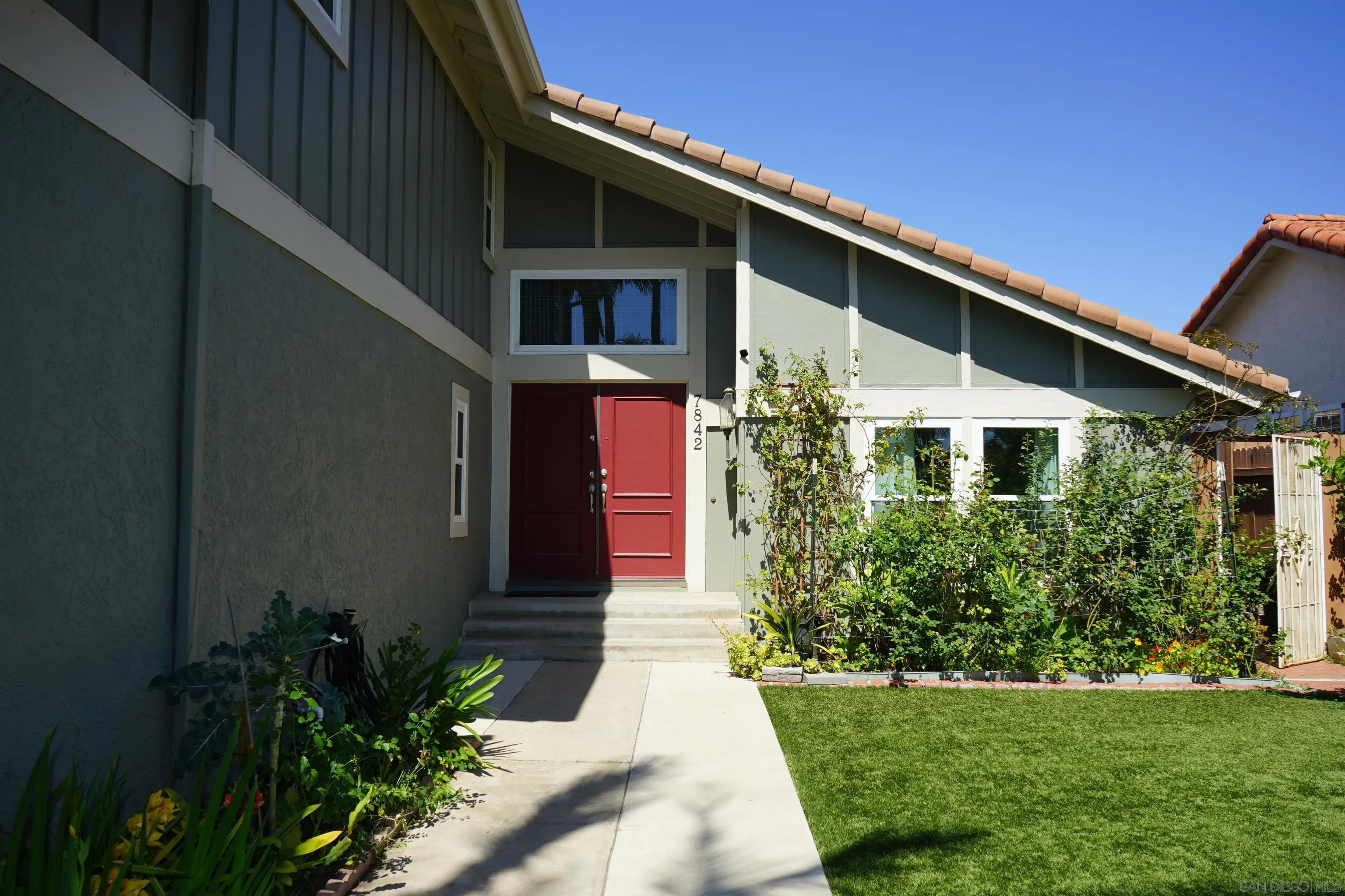 7842 Hemphill Drive San Diego, CA 92126 - Photo 3 of 29 a front view of a house with a yard