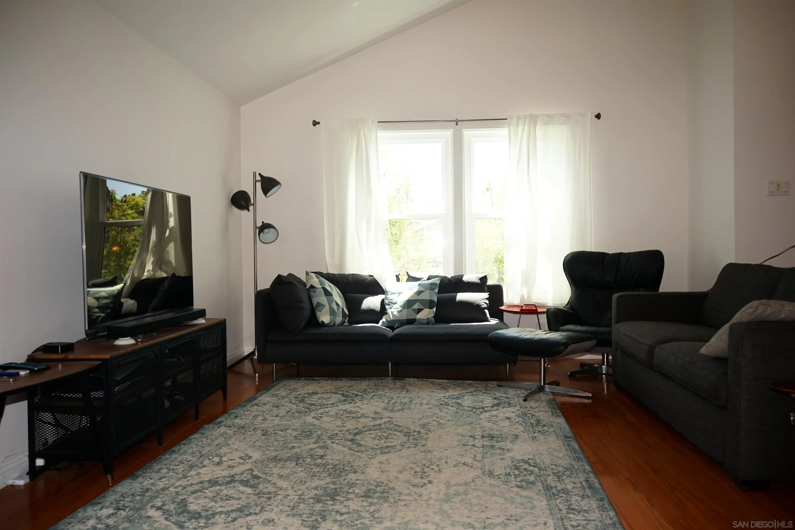 7842 Hemphill Drive San Diego, CA 92126 - Photo 6 of 29 a living room with furniture flat screen tv and a window