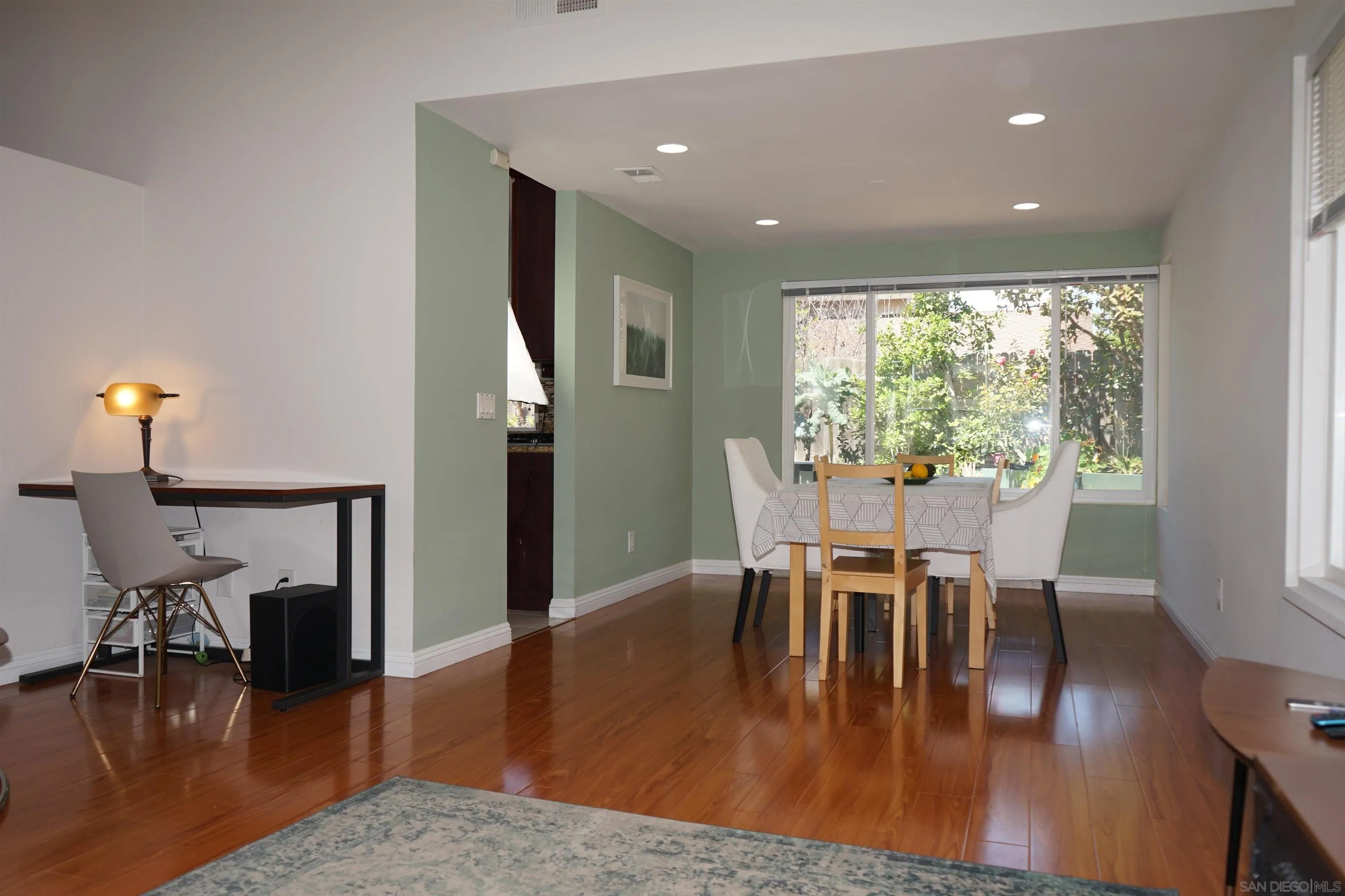 7842 Hemphill Drive San Diego, CA 92126 - Photo 7 of 29 a dining room with furniture a chandelier and wooden floor
