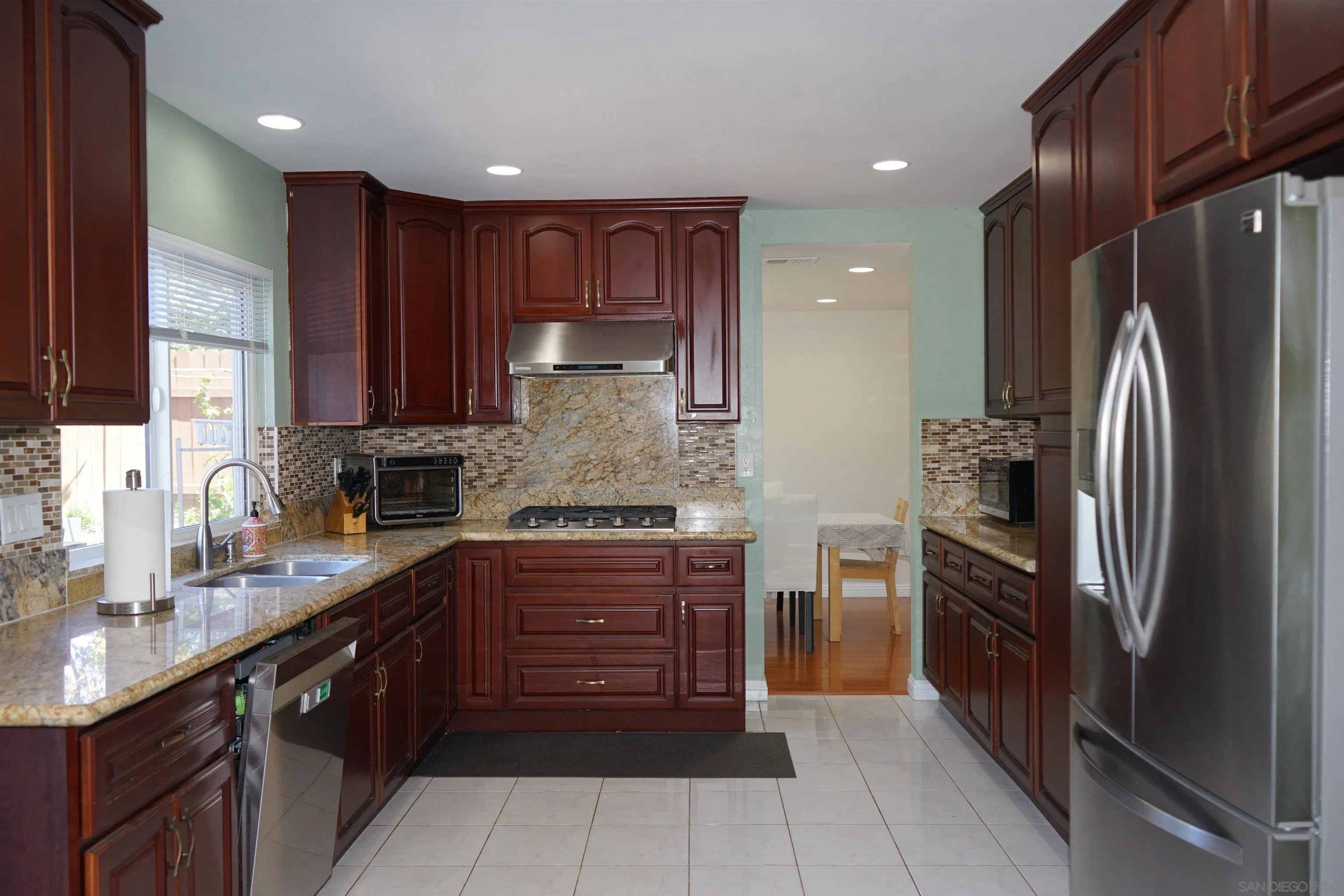 7842 Hemphill Drive San Diego, CA 92126 - Photo 10 of 29 a large kitchen with stainless steel appliances granite countertop a refrigerator and a sink