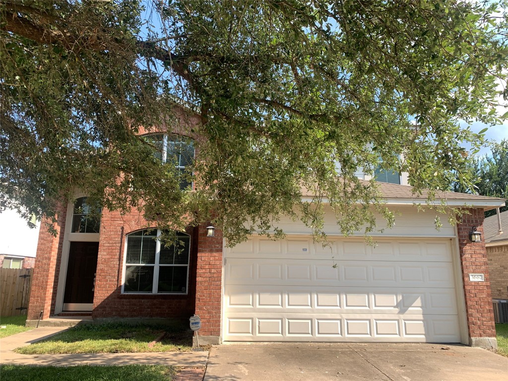 3667 Spring Canyon Trail Round Rock, TX 78681 - Photo 2 of 24 a front view of a house with a tree