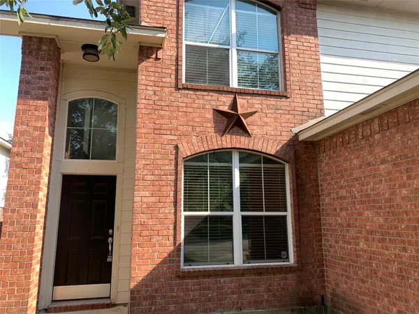 a front view of a house with large windows