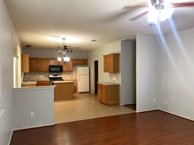 a kitchen with kitchen island cabinets and refrigerator