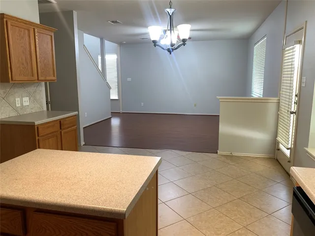 a kitchen with kitchen island a counter top space appliances and cabinets