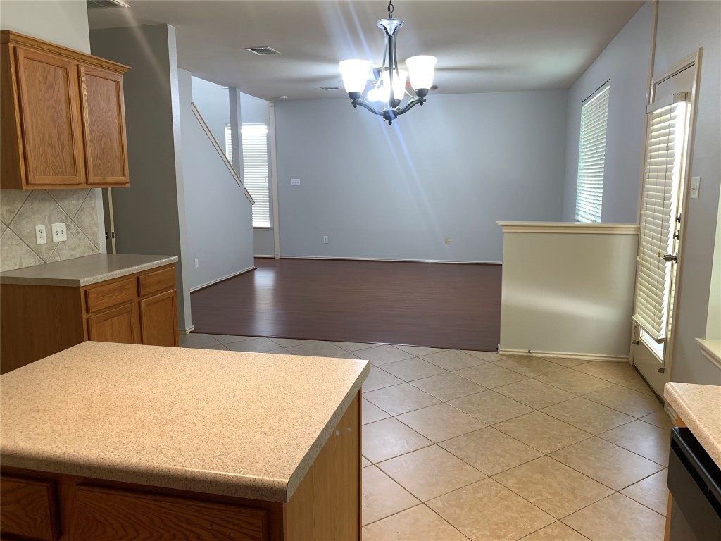 3667 Spring Canyon Trail Round Rock, TX 78681 - Photo 10 of 24 a kitchen with kitchen island a counter top space appliances and cabinets