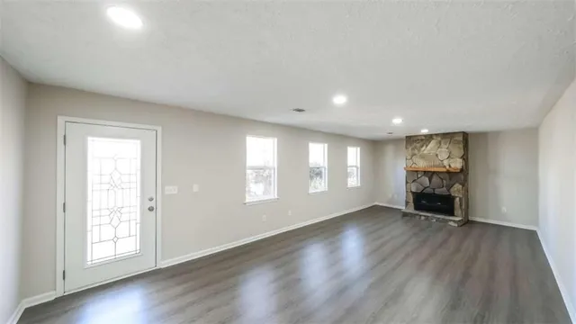 an empty room with windows and closet