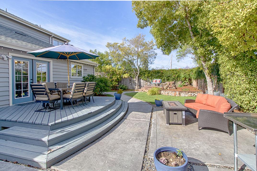 2230 Albert Lane Capitola, CA 95010 - Photo 2 of 34 a view of a patio with table and chairs potted plants and a large tree