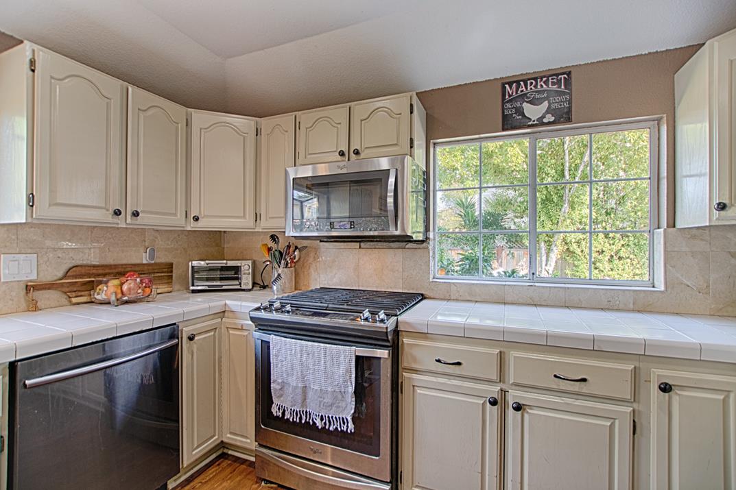 2230 Albert Lane Capitola, CA 95010 - Photo 12 of 34 a kitchen with granite countertop a stove a sink and a microwave