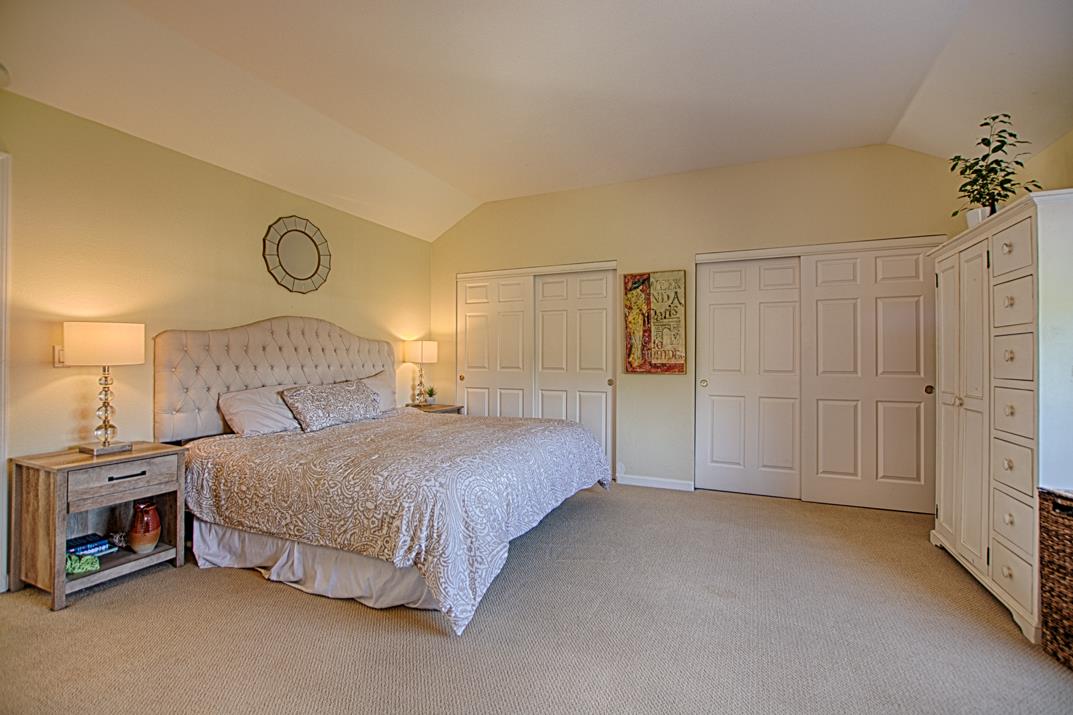 2230 Albert Lane Capitola, CA 95010 - Photo 15 of 34 a spacious bedroom with a bed and a lamp