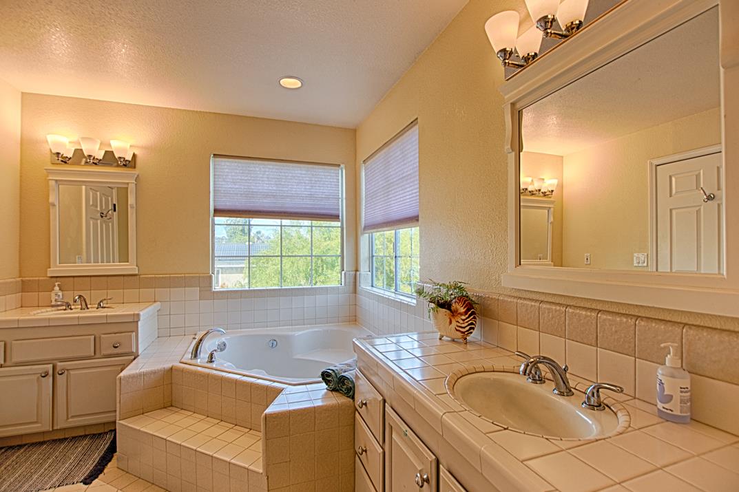 2230 Albert Lane Capitola, CA 95010 - Photo 16 of 34 a bathroom with a tub a sink double vanity and a mirror