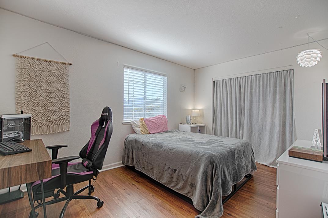 2230 Albert Lane Capitola, CA 95010 - Photo 18 of 34 a bedroom with a bed a desk and chair