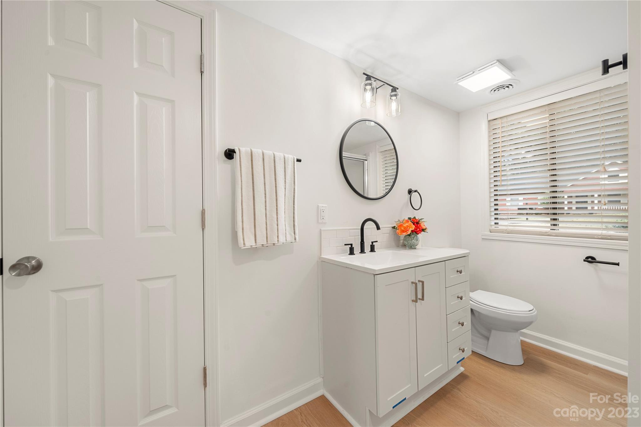 2130 Manawa Lane Tega Cay, SC 29708 - Photo 26 of 43 a bathroom with a toilet a sink a vanity and a window
