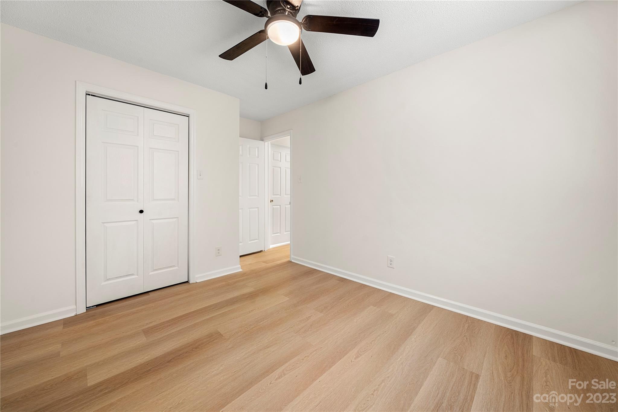 2130 Manawa Lane Tega Cay, SC 29708 - Photo 35 of 43 an empty room with wooden floor and windows