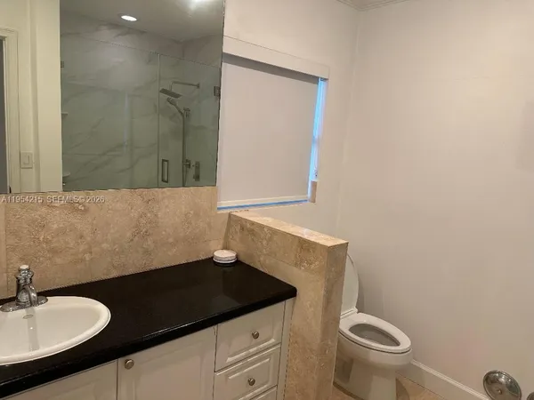 a bathroom with a shower and a toilet