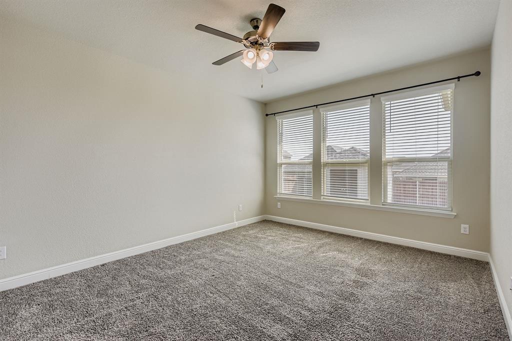 1829 Ruffian Road Granbury, TX 76049 - Photo 14 of 39 an empty room with chandelier fan and windows