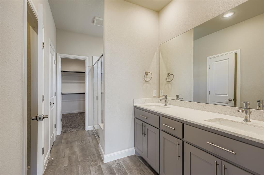 1829 Ruffian Road Granbury, TX 76049 - Photo 17 of 39 a bathroom with a sink and a mirror