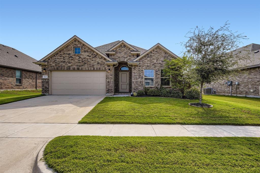 1829 Ruffian Road Granbury, TX 76049 - Photo 2 of 39 a front view of a house with a yard and garage