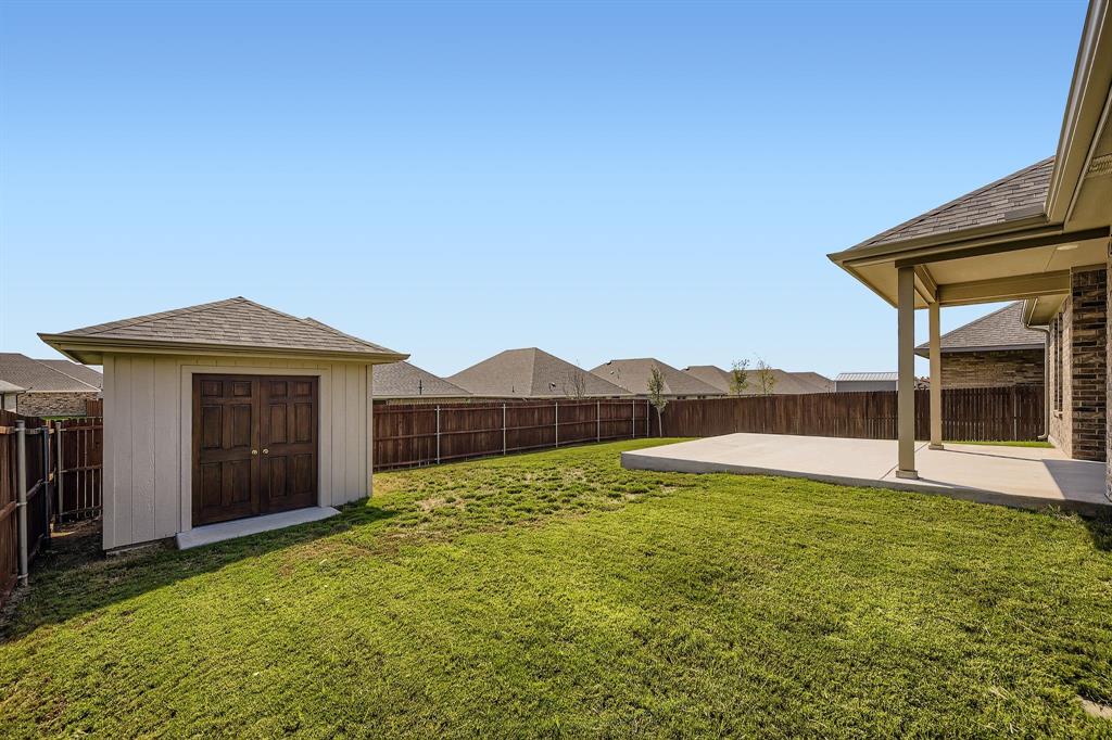 1829 Ruffian Road Granbury, TX 76049 - Photo 27 of 39 a view of a house with a yard and a large tree
