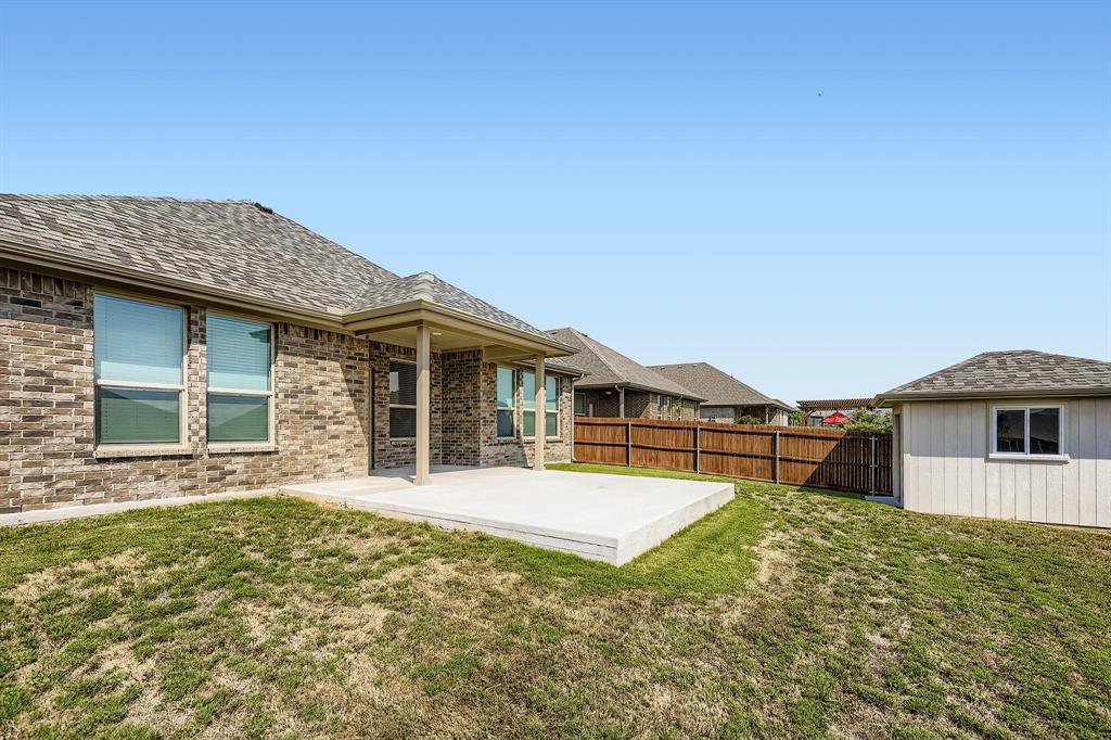1829 Ruffian Road Granbury, TX 76049 - Photo 28 of 39 a view of a house with a yard and sitting area
