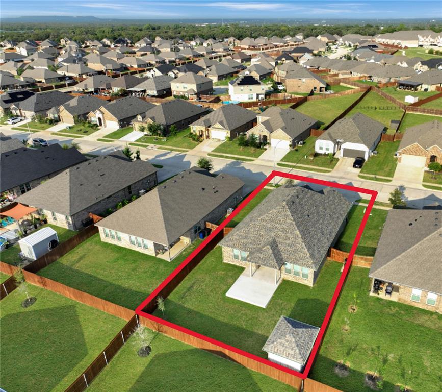 1829 Ruffian Road Granbury, TX 76049 - Photo 32 of 39 an aerial view of a tennis ground and a cars park