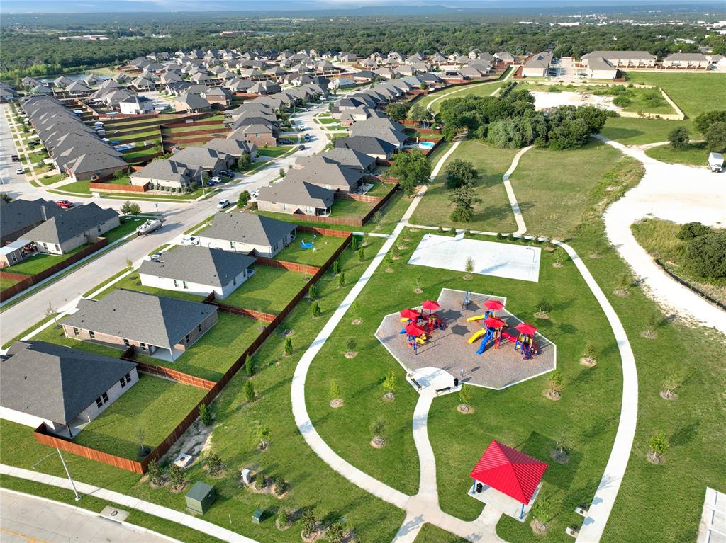 1829 Ruffian Road Granbury, TX 76049 - Photo 37 of 39 an aerial view of a swimming pool a playground lake and mountain view in back