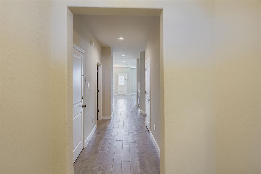1829 Ruffian Road Granbury, TX 76049 - Photo 5 of 39 a view of a hallway with wooden floor